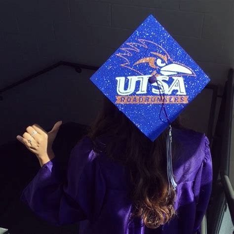 a female student wearing a purple graduation cap and gown