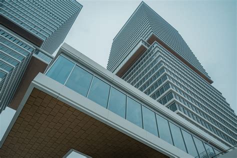 A Very Tall Building Sitting Next To A Very Tall Building Photo Free