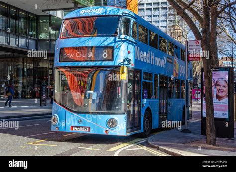 A blue, no. 8, double decker bus at a bus stop in St Giles High Street ...