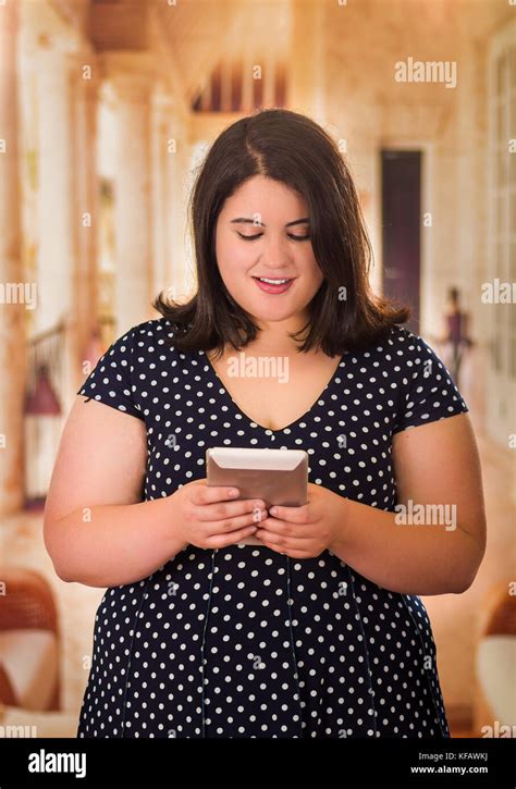 Close Up Of Beautiful Fat Woman In A Beautiful Dress Using Her Tablet