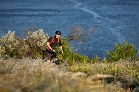 Attractive Cyclist Riding The Mountain Bicyclist On The Summer Trail