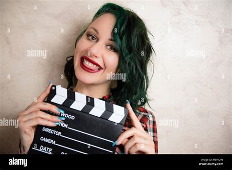 Young Alternative Girl Smiling Face Posing With Movie Clapper Board For