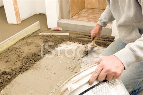 Tile Worker Spreading Thinset Mortar On Bathroom Floor Stock Photo | Royalty-Free | FreeImages