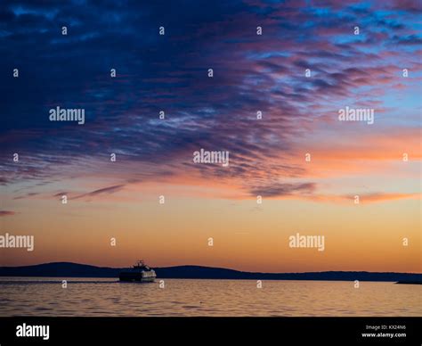 Ship Sailing Into The Sunset Stock Photo Alamy