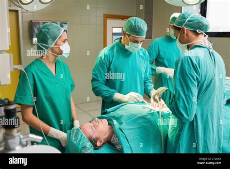 Female Patient Lying On A Table Undergoing Surgery Stock Photo Alamy