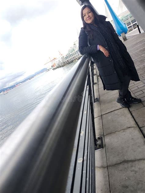 A Year Old Latina Woman Enjoys The View Of The Sea At The Port In Downtown Vancouver Canada