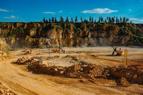 Excavarors Working On Limestone Mining In The Quarry Stock Photo