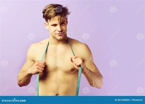 Man With Smiling Face And Naked Torso With Flexible Ruler Stock Photo