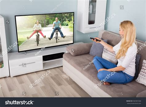 Young Woman Sitting On Couch Watching Stock Photo 582987268 - Shutterstock