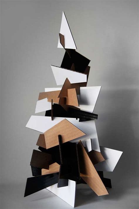 An Abstract Christmas Tree Made Out Of Wood And White Paper With Black