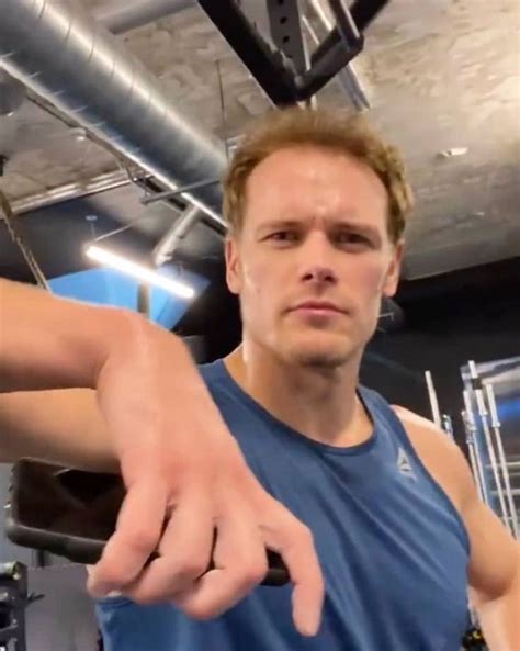 A Man Pointing At The Camera While Standing In Front Of A Gym Equipment