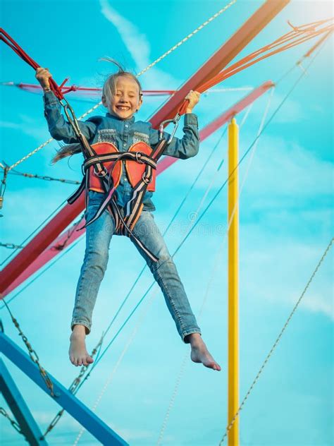 Menina Feliz Amarrada Com As Correias Que Balançam A Atração Fechado Do