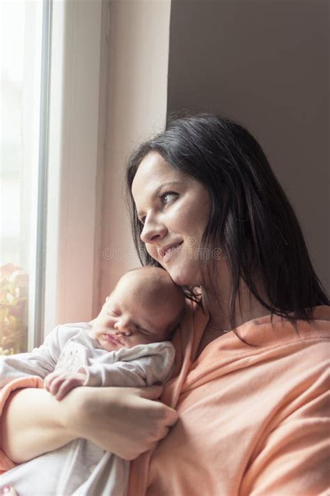 Pretty Woman Holding A Newborn Baby In Her Arms Stock Photo Image Of