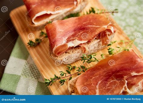 Sandwiches Made From Hand Made Rye Bread And Thin Chopped Fresh Bacon Fresh Green Thyme On A