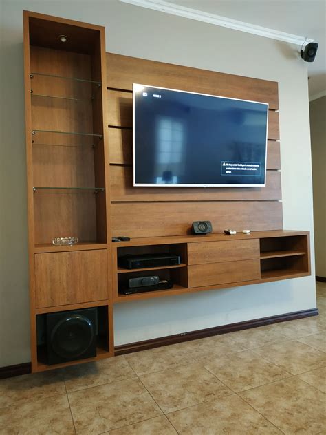 An Entertainment Center With A Large Flat Screen Tv Mounted On It S