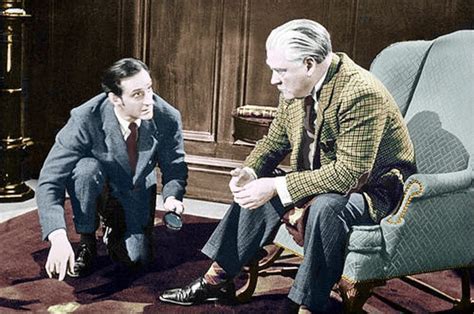 Two Men Sitting In Chairs Talking To Each Other