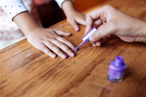 Mother Applying Nail Polish On Her Daughters Nail By Stocksy