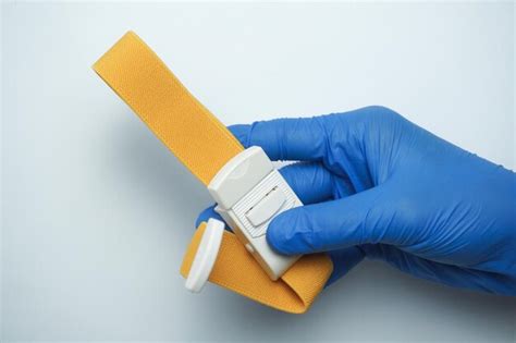 Premium Photo Doctor Wearing Blue Medical Gloves Holding A Yellow