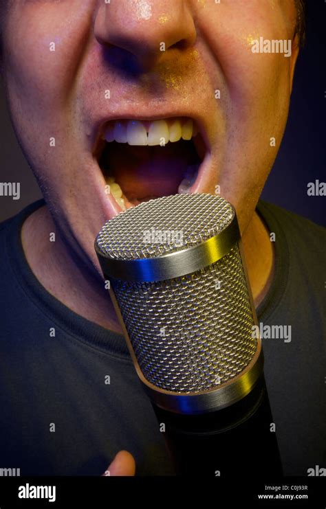 Passionate Male Vocalist Sings Into A Microphone Stock Photo Alamy