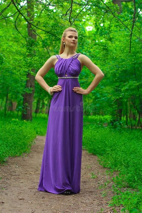 Blonde Beautiful Natural Girl With Blonde Hair In A Lilac Dress In Nature In The Park In The