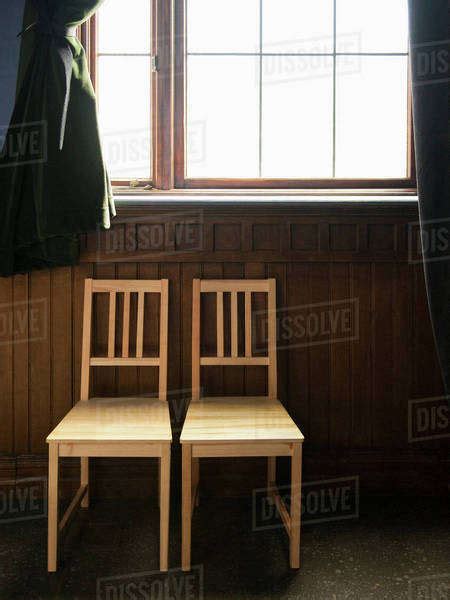 Two Empty Chairs Beneath A Window Stock Photo Dissolve