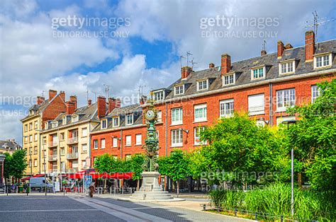 Dewailly Naked Mary Clock Monument On Square And Brick Buildings In Old