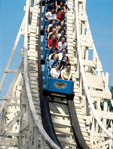 Several People Are Riding On A Roller Coaster