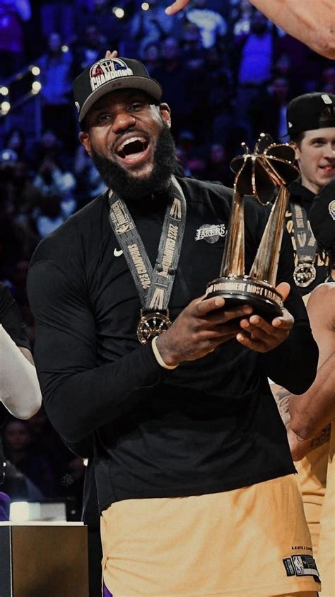 The Lakers Players Are Holding Trophies In Their Hands