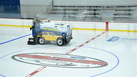 Park and Rec employees training on Zamboni in new ice arena