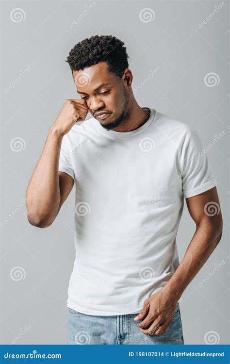 African American Man In White T Short Crying And Looking Down Stock