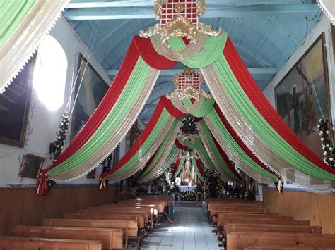 The Interior Of A Church Decorated With Red Green And White Draping