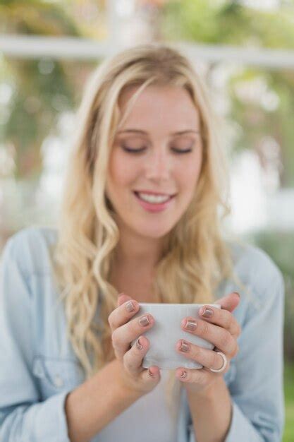Premium Photo Pretty Blonde Sitting At Table Having Coffee