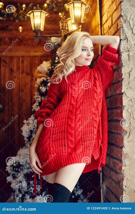 Fashion Woman The Blonde In The Red Sweater Having Fun And Posing Against The Christmas Tree