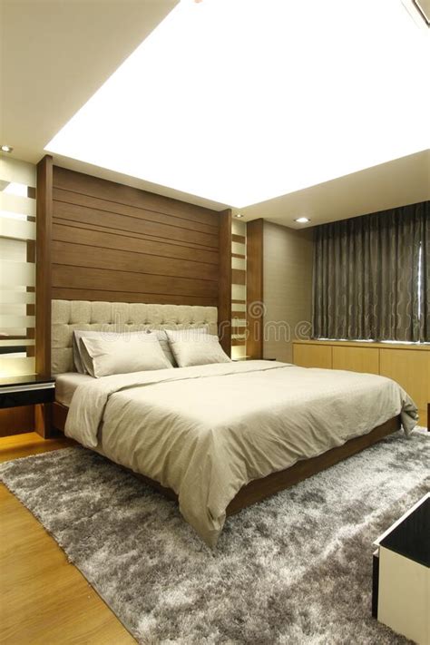 Neat Made Up Bed in a Main Bedroom with Warm Colors and a Cozy Modern ...