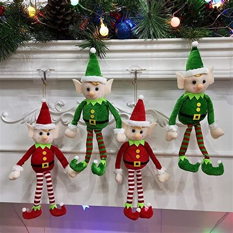 three elf stuffed animals hanging from a mantel