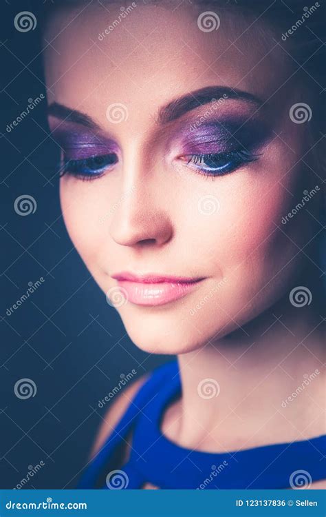 Studio Shot Of A Beautiful Young Woman Wearing Professional Makeup