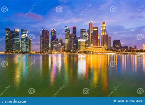 Night View Of Singapore City Downtown Skyline And Skyscrapers Marina