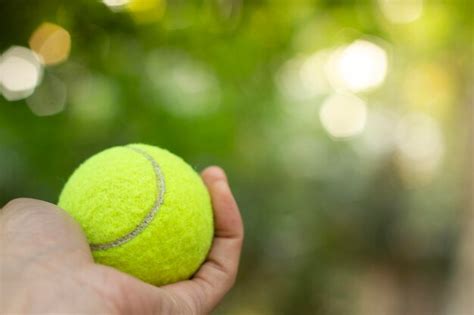 Premium Photo Close Up Of Hand Holding Tennis Ball