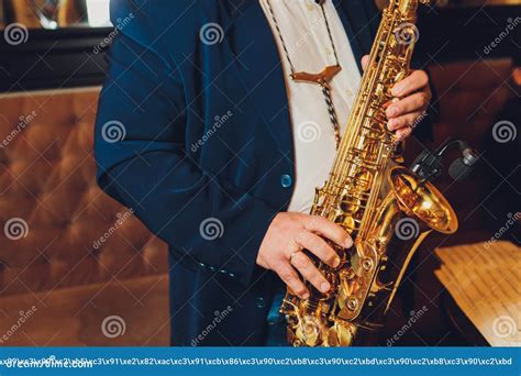 Saxophone Classical Music Instrument Saxophonist With Alto Sax Closeup On Black Stock Image