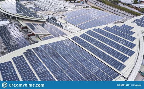 Aerial View Of A Solar Panel Photovoltaic With Reflection On Building