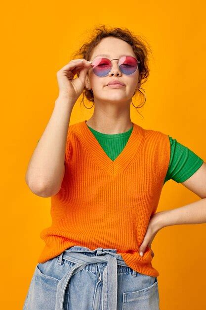 Premium Photo Young Woman Wearing Sunglasses While Standing Against