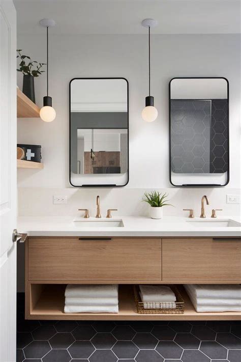 A Bathroom With Two Sinks And Mirrors On The Wall