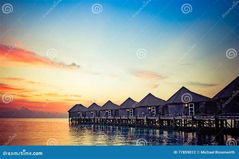 Water bungalows at sunset stock photo. Image of outdoors - 77859012