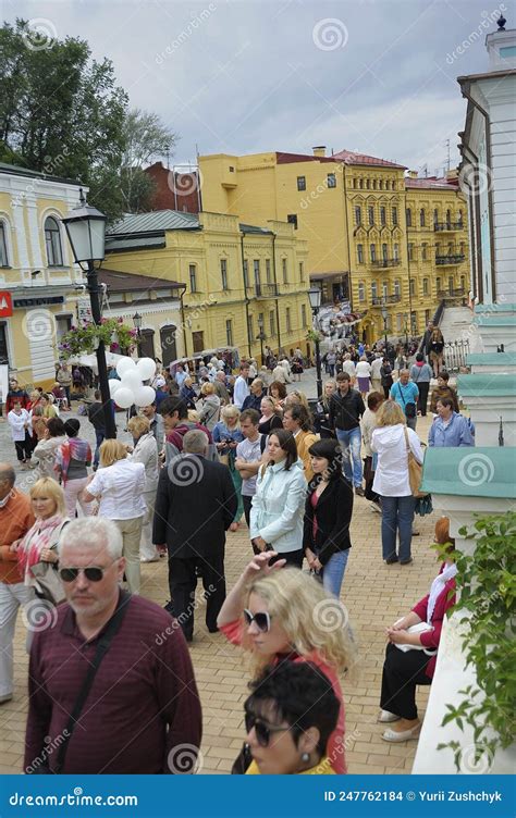 Crowd Of People Walking Down The Street Buildings On A Background