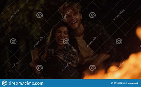 Fun Couple Laugh Together On Night Camp Site Smiling Millennials Date