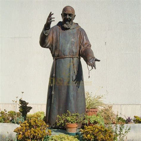 Bronze Statue Of St Padre Pio Stands In The Garden