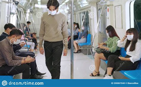 Crowd Of People Wearing Face Mask On A Crowded Public Subway Train