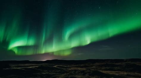 Premium AI Image | A green aurora borealis is lit up in the night sky.