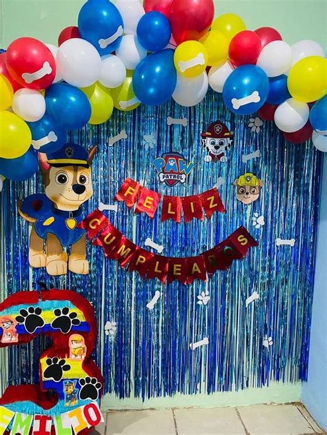 A Birthday Decoration With Balloons And Streamers For A Paw Patrol