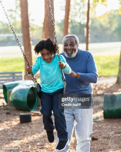 grandparent pushing swing   premium high res pictures getty